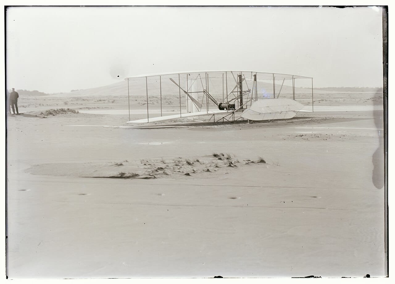 Damaged 1903 Wright Flyer on the sand after its fourth flight