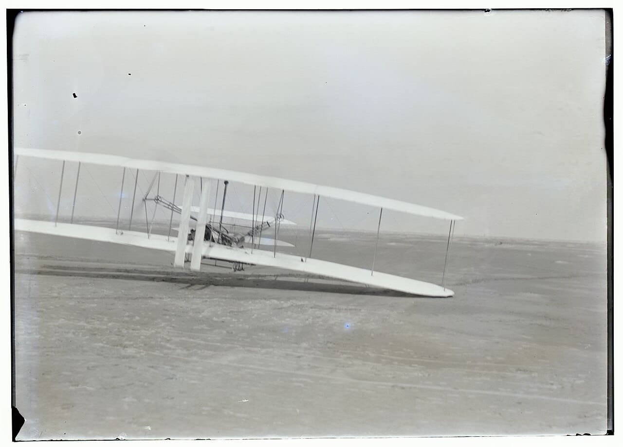 Wright Flyer mid-flight during the third of four flights on December 17, 1903