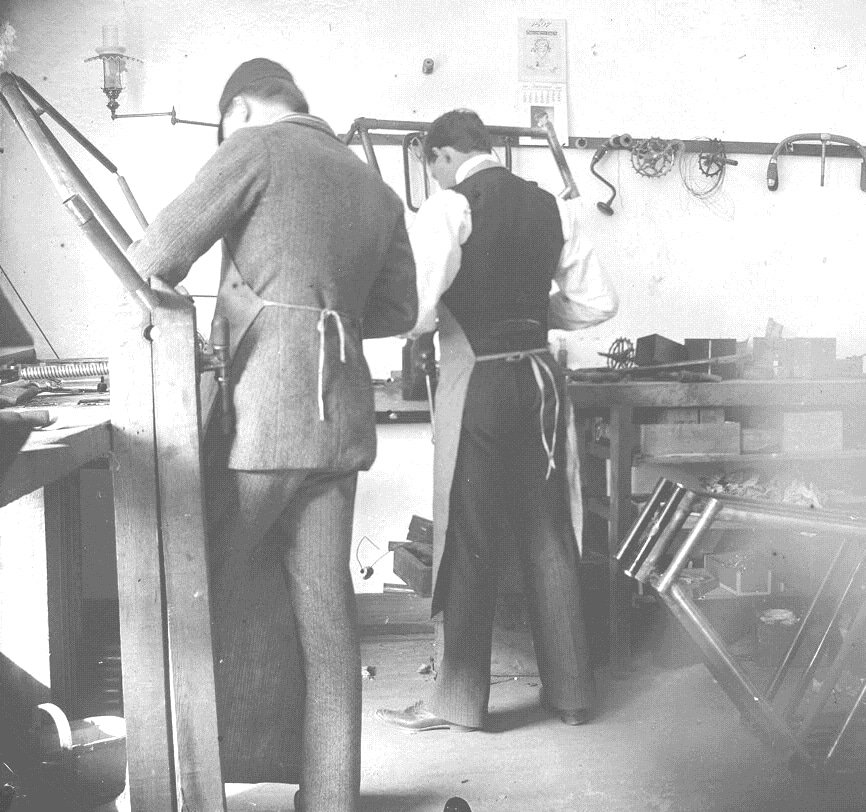 Orville Wright working in the bicycle shop with Edwin Sines in 1897